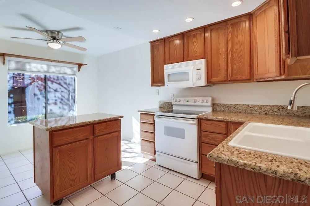 2157 Arnold Way, Unit 201 Alpine, CA 91901 - Photo 17 of 41 a kitchen with stainless steel appliances granite countertop a sink counter space cabinets and a window