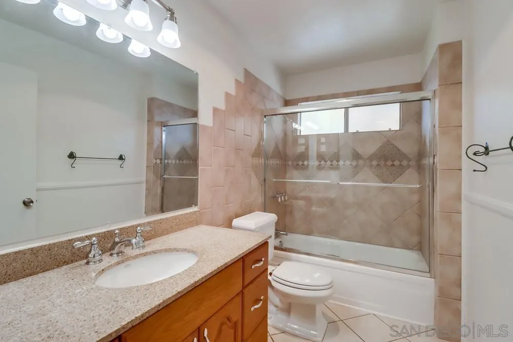 2157 Arnold Way, Unit 201 Alpine, CA 91901 - Photo 18 of 41 a bathroom with a granite countertop sink toilet mirror and shower