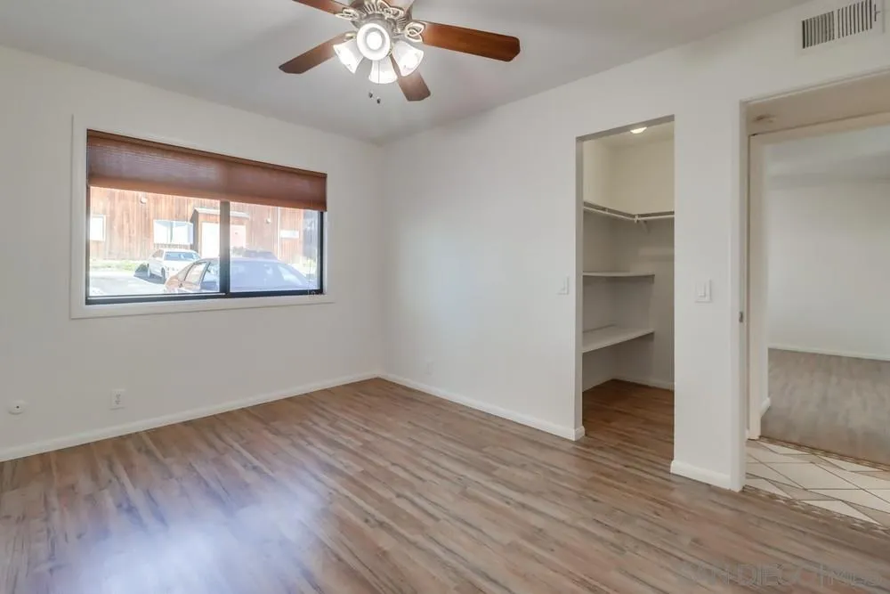 2157 Arnold Way, Unit 201 Alpine, CA 91901 - Photo 21 of 41 a view of an empty room with wooden floor and a window