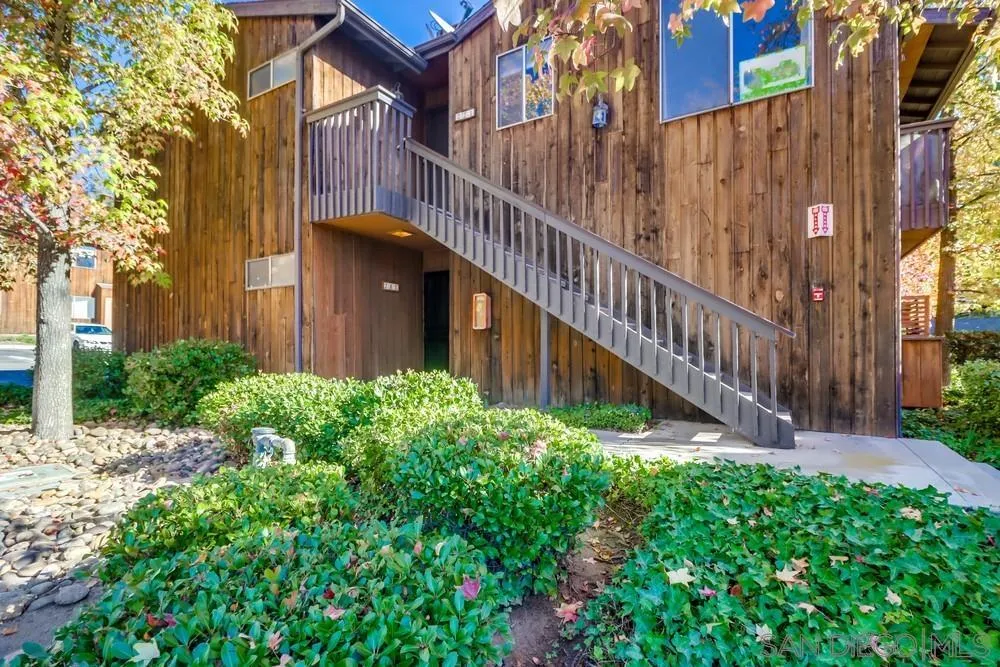 2157 Arnold Way, Unit 201 Alpine, CA 91901 - Photo 3 of 41 a view of a house with brick walls and a small yard