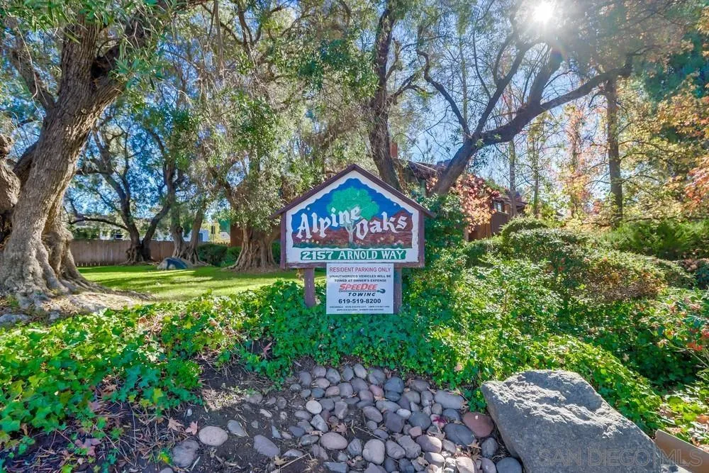 2157 Arnold Way, Unit 201 Alpine, CA 91901 - Photo 41 of 41 a sign that is sitting in front of a brick house with large trees