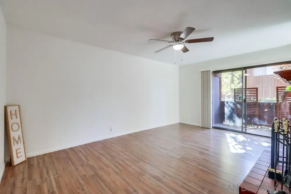 2157 Arnold Way, Unit 201 Alpine, CA 91901 - Photo 7 of 41 an empty room with wooden floor fan and windows