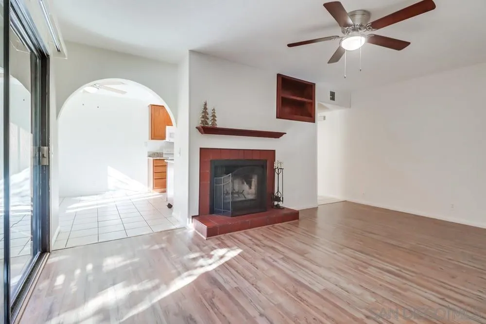 2157 Arnold Way, Unit 201 Alpine, CA 91901 - Photo 9 of 41 a view of a livingroom with a fireplace a ceiling fan and closet