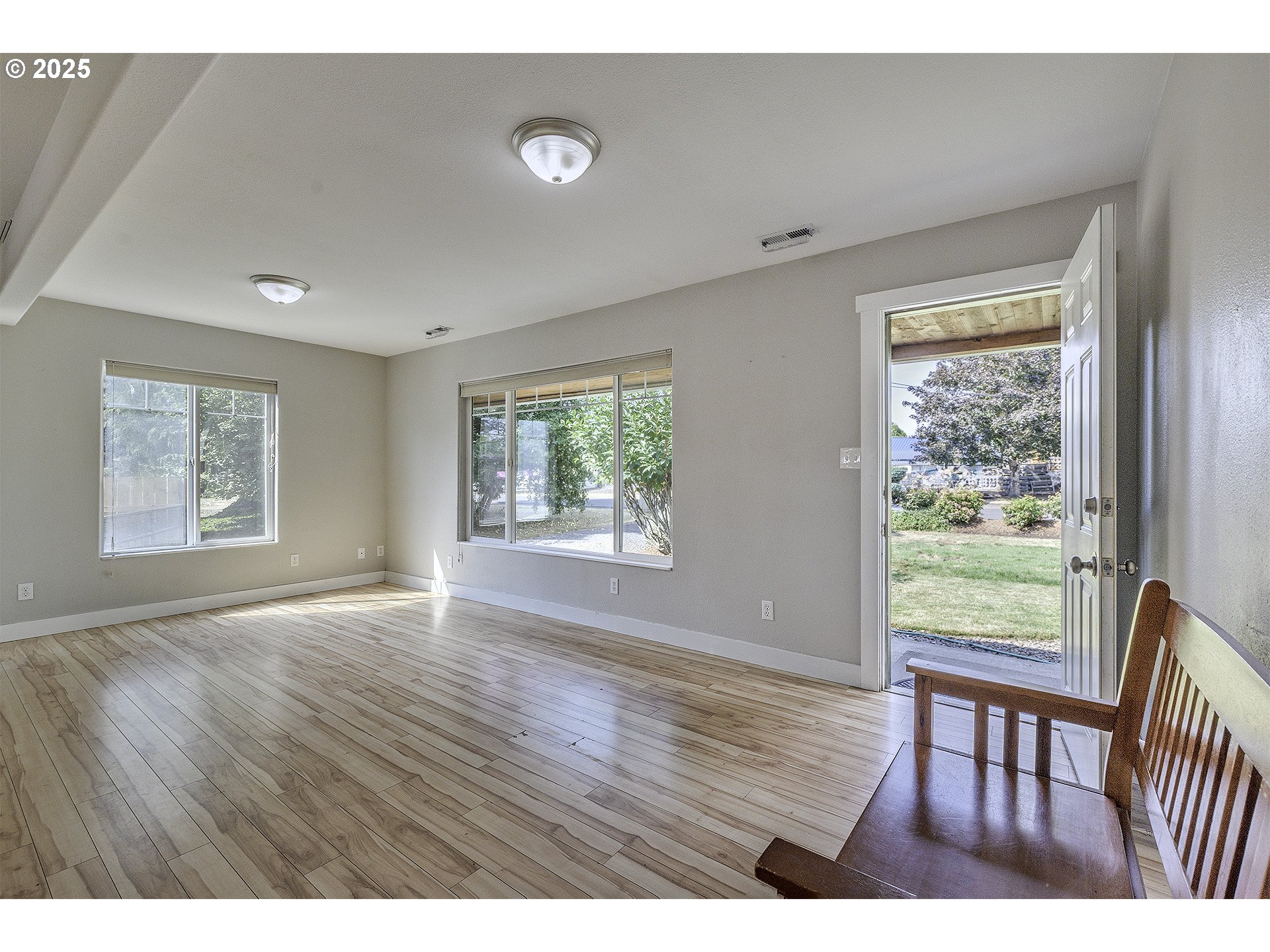 2319 Hawthorne Street Forest Grove, OR 97116 - Photo 3 of 33 an empty room with wooden floor and windows