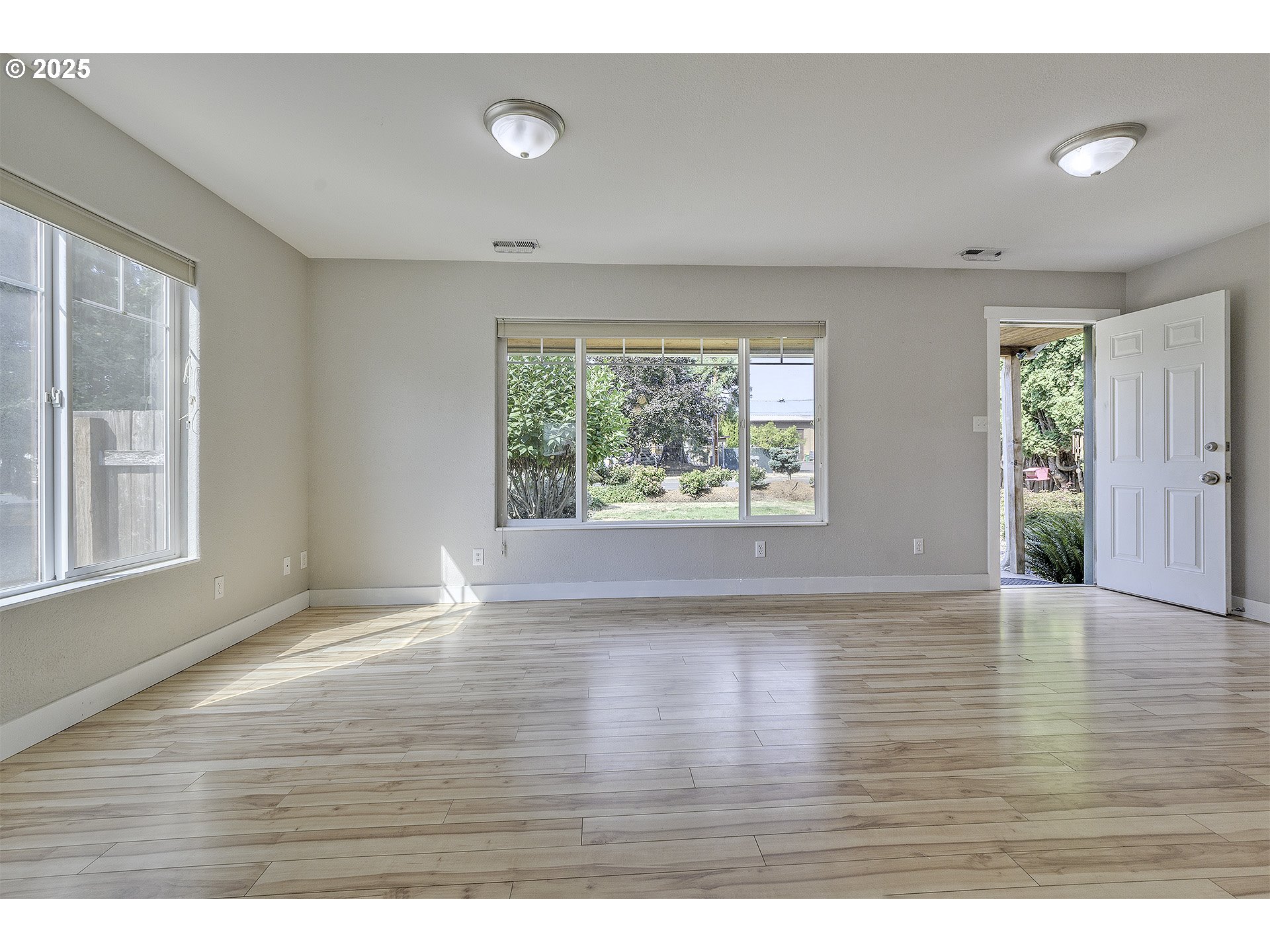 2319 Hawthorne Street Forest Grove, OR 97116 - Photo 5 of 33 a view of an empty room with wooden floor and a window