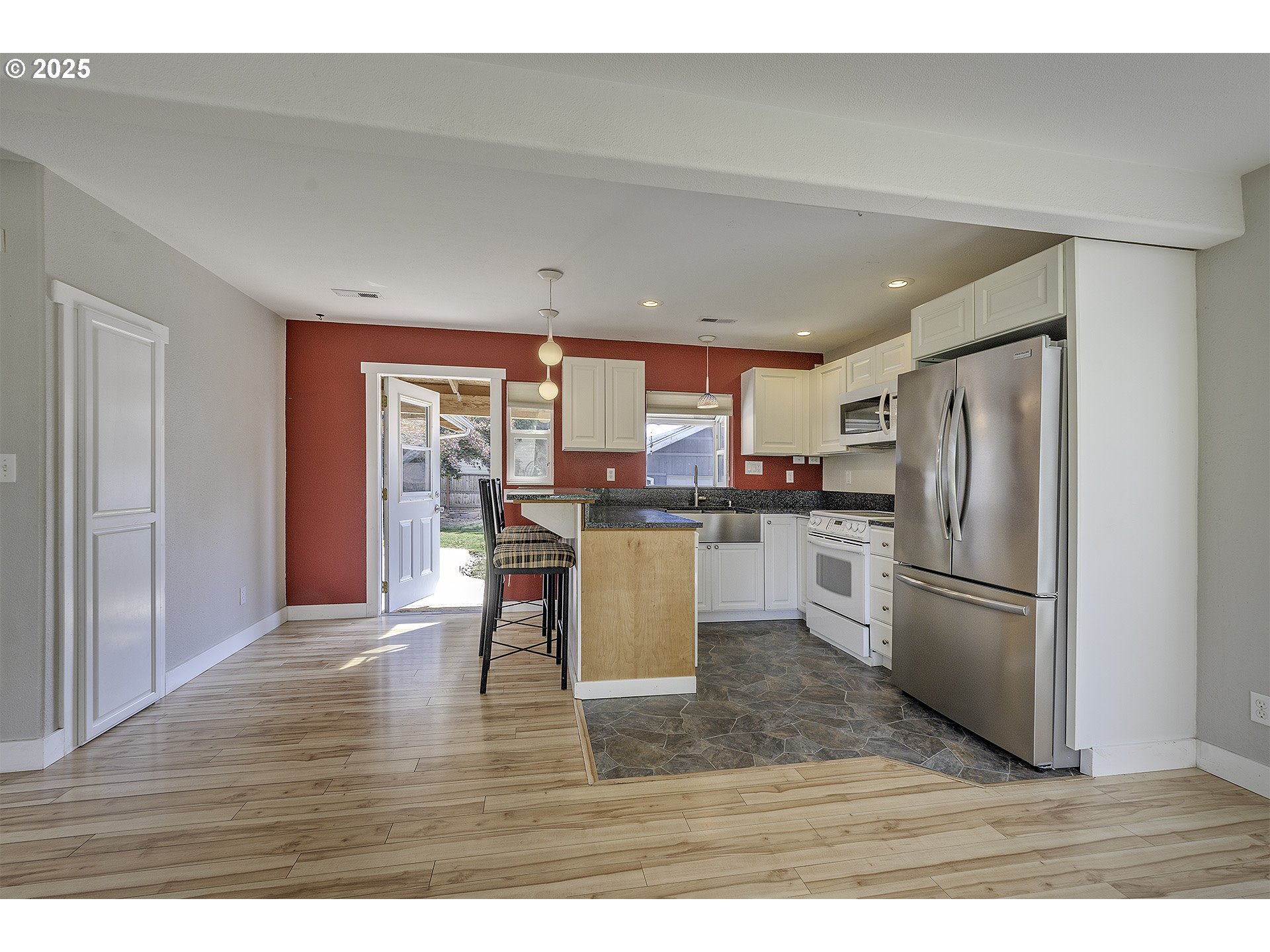 2319 Hawthorne Street Forest Grove, OR 97116 - Photo 8 of 33 a kitchen with a refrigerator a stove top oven and kitchen island