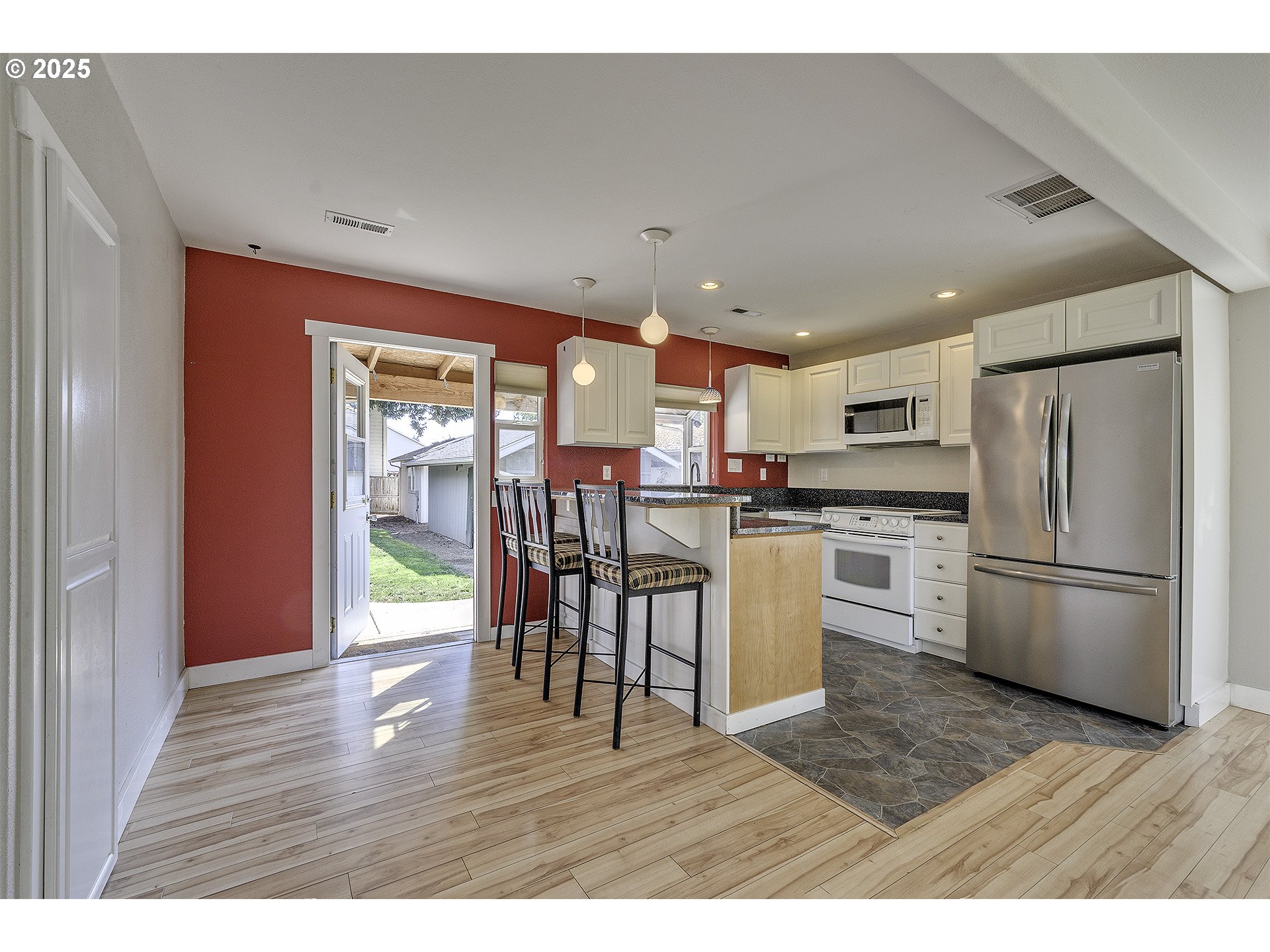 2319 Hawthorne Street Forest Grove, OR 97116 - Photo 10 of 33 a kitchen with a refrigerator a microwave oven a sink dishwasher with a dining table and chairs