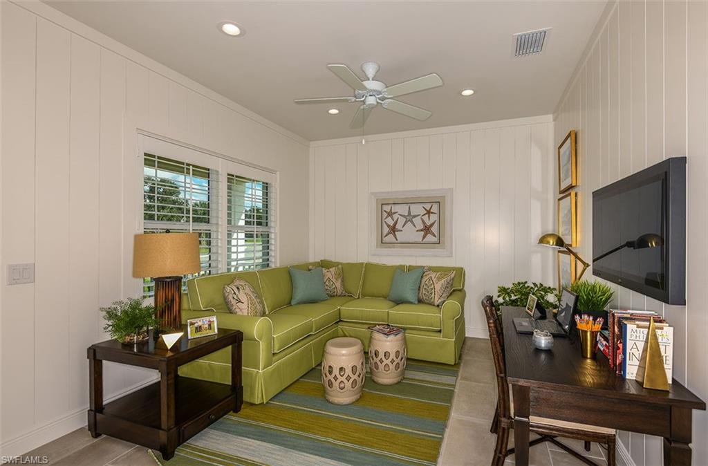 4048 Pegasus Way Naples, FL 34120 - Photo 11 of 13 a living room with furniture and a flat screen tv