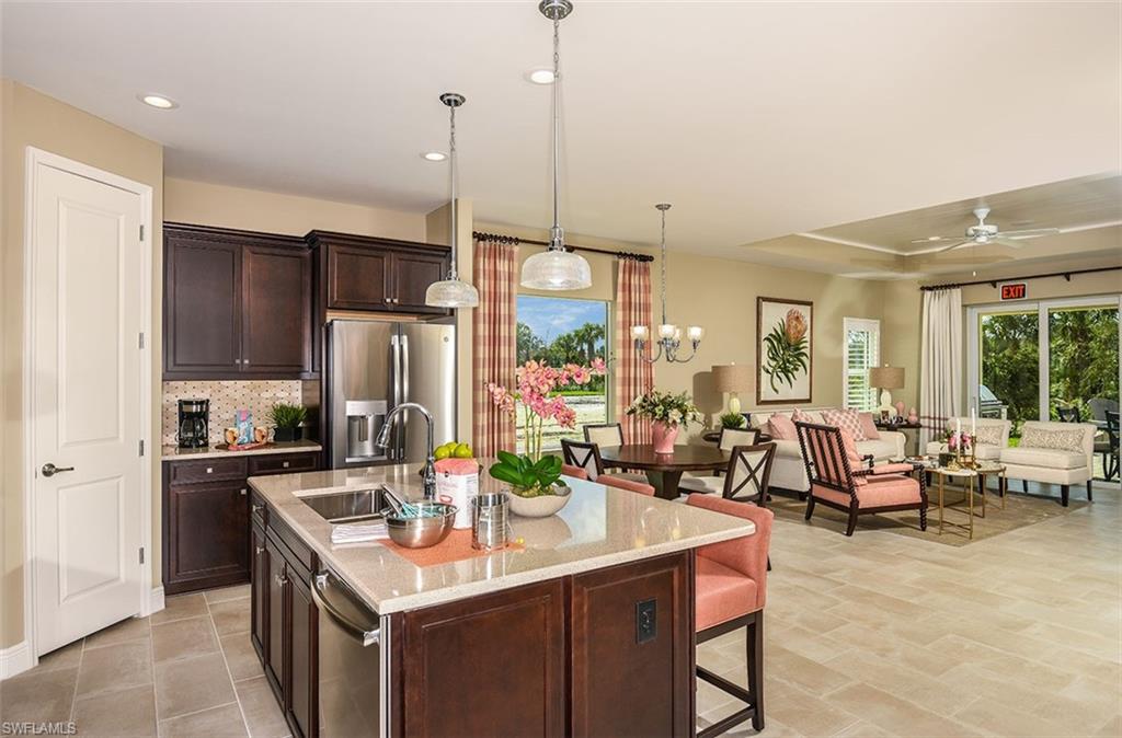 4048 Pegasus Way Naples, FL 34120 - Photo 7 of 13 a kitchen with kitchen island a large counter top space a sink stainless steel appliances and cabinets