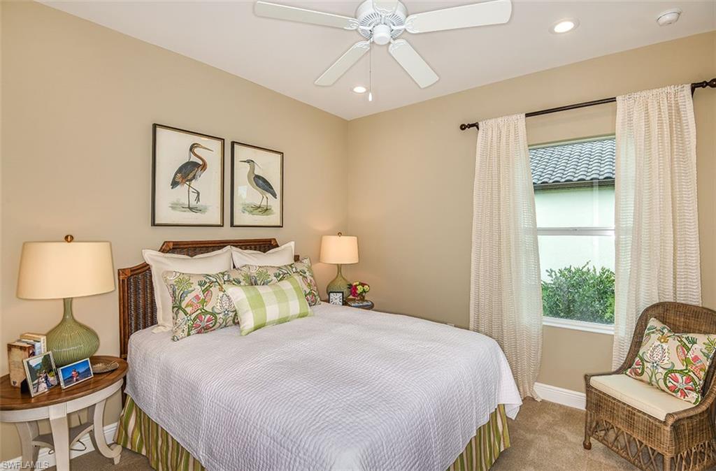 4048 Pegasus Way Naples, FL 34120 - Photo 9 of 13 a bedroom with a bed and wooden floor