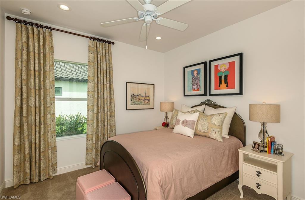 4048 Pegasus Way Naples, FL 34120 - Photo 10 of 13 a bedroom with a bed and a chandelier