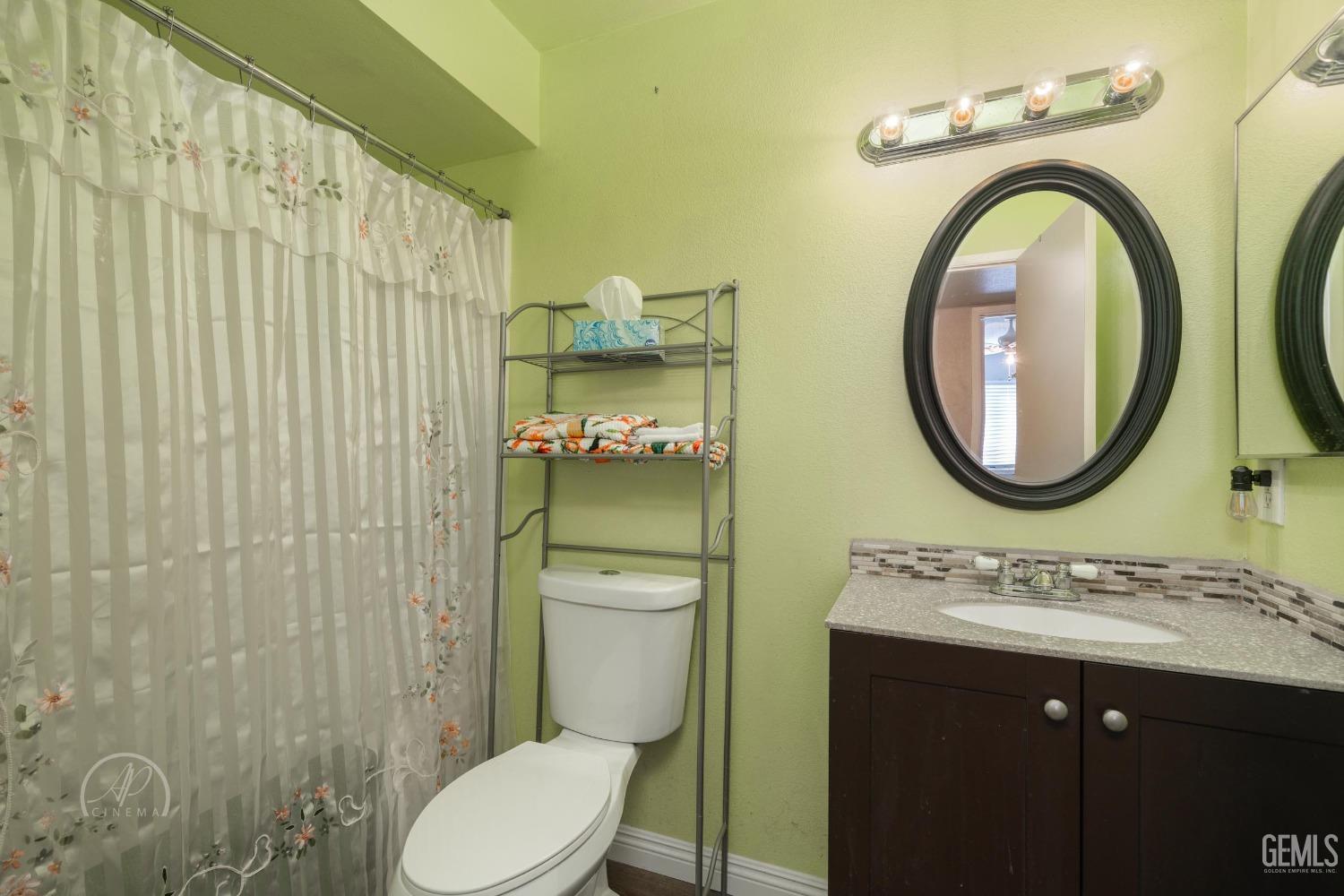 Undisclosed Address Taft, CA 93268 - Photo 16 of 32 a bathroom with a toilet a sink and mirror
