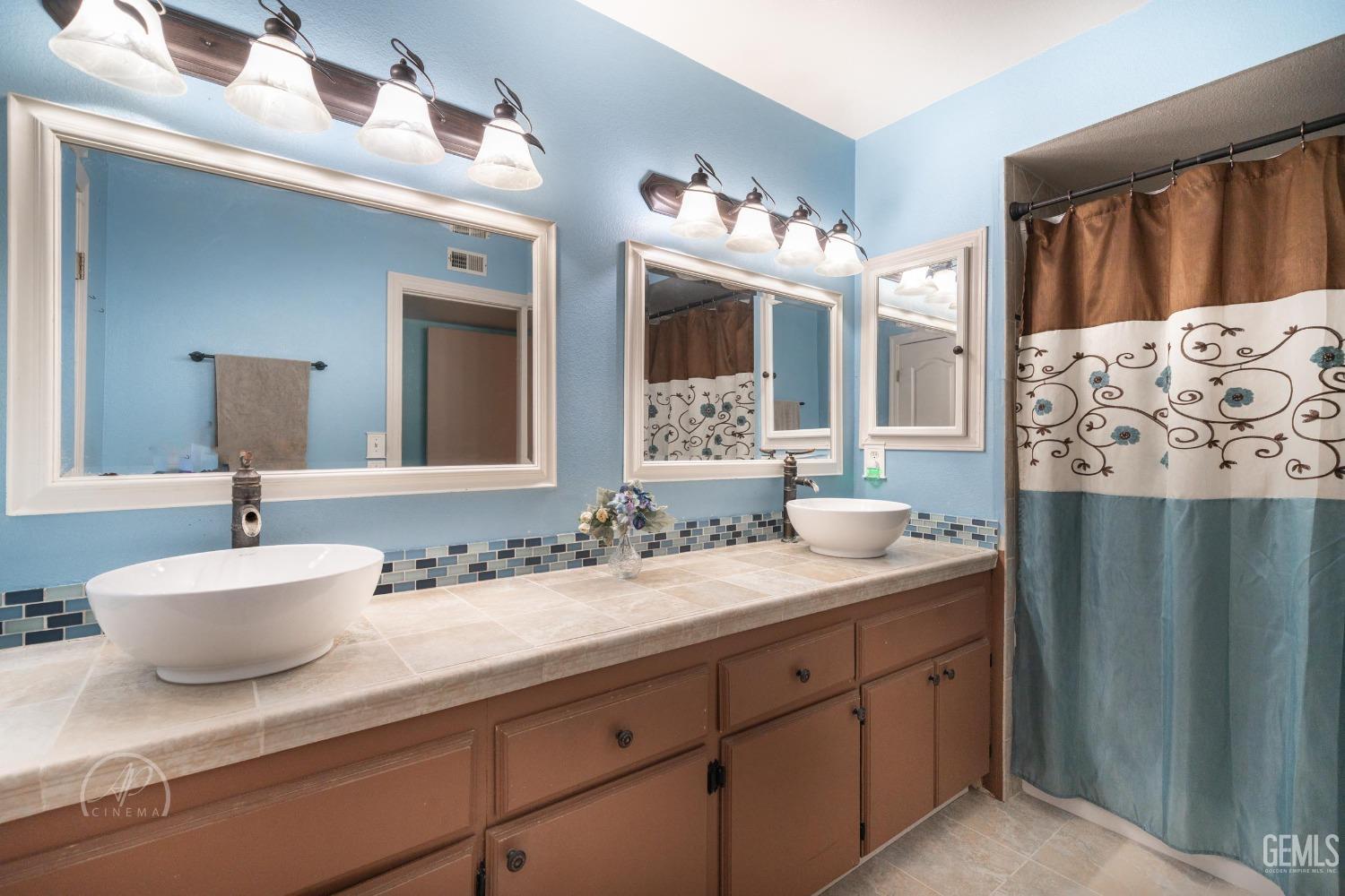 Undisclosed Address Taft, CA 93268 - Photo 19 of 32 a bathroom with a sink double vanity and a mirror