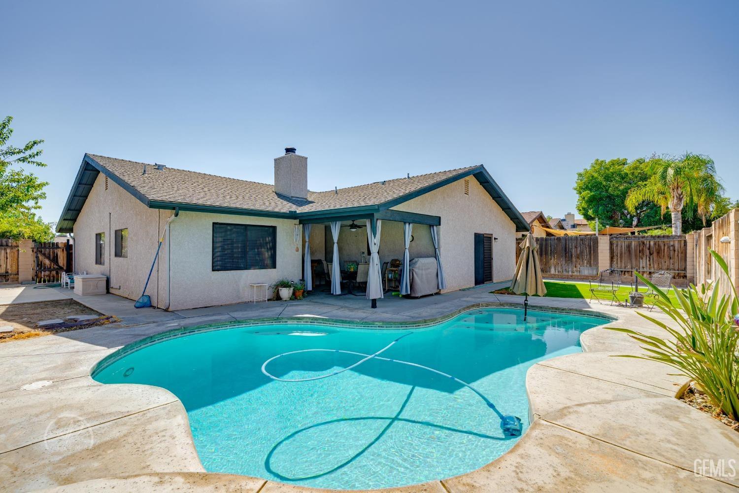 Undisclosed Address Taft, CA 93268 - Photo 21 of 32 a view of a house with a backyard and a patio