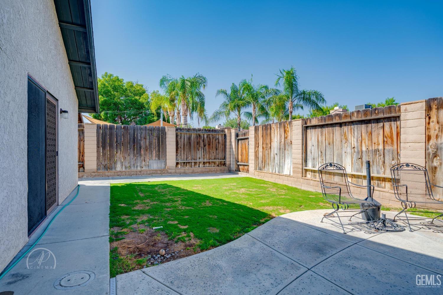 Undisclosed Address Taft, CA 93268 - Photo 23 of 32 a view of a backyard with a garden and a tree
