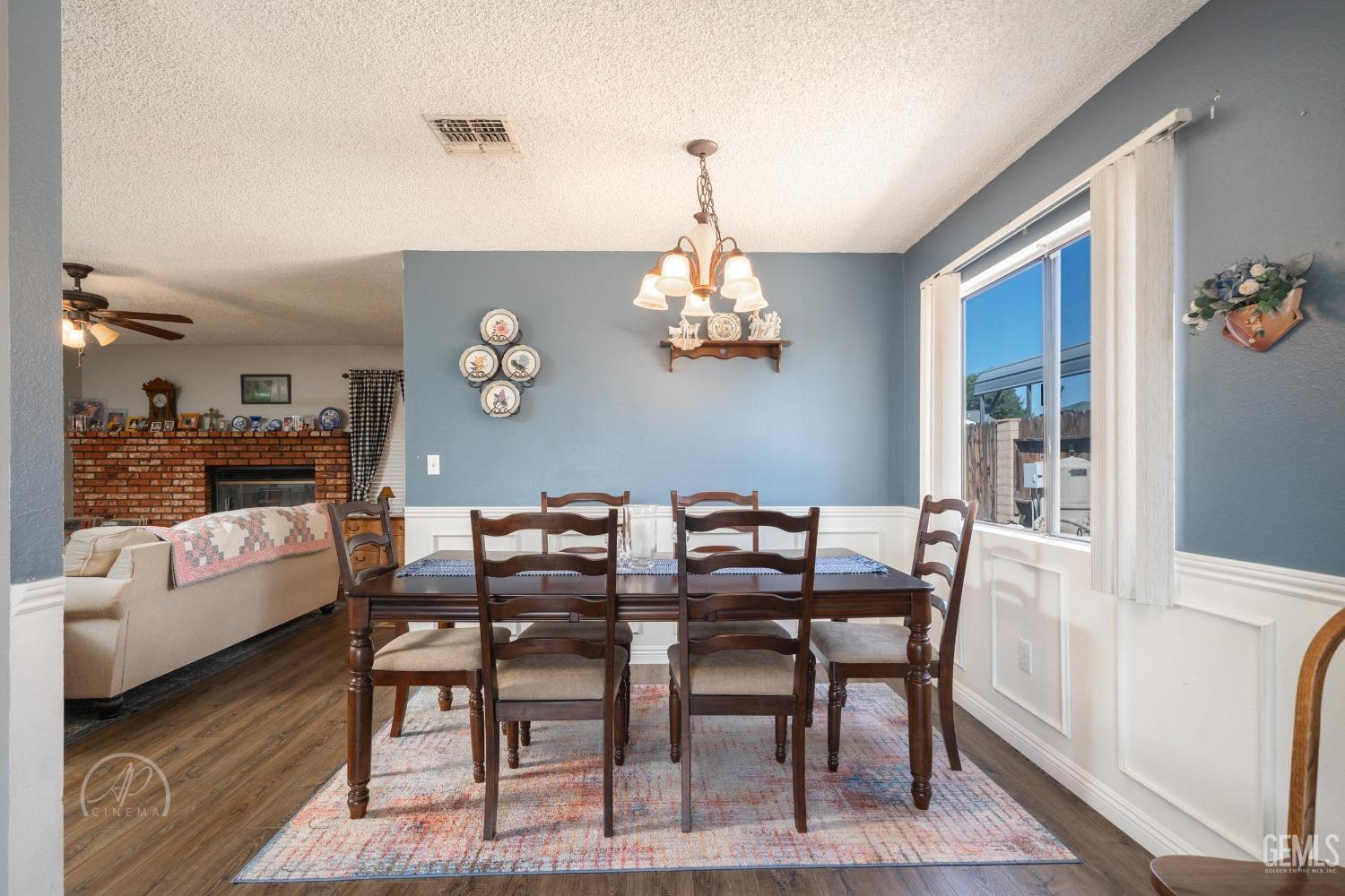 Undisclosed Address Taft, CA 93268 - Photo 6 of 32 a view of a dining room with furniture wooden floor and a chandelier