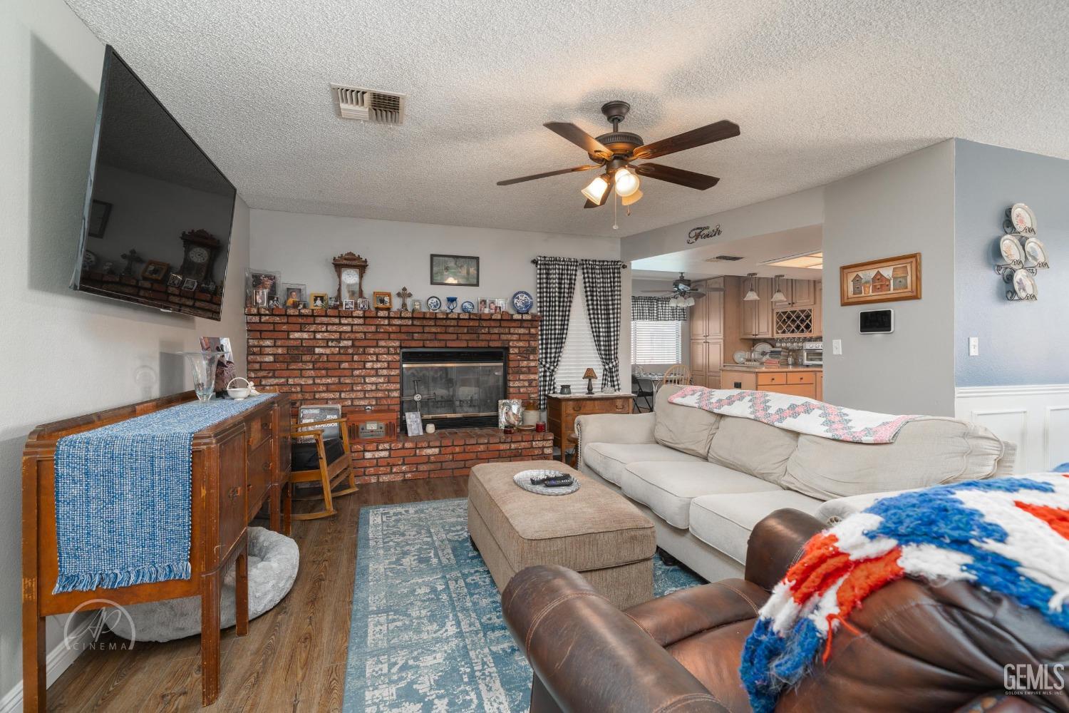 Undisclosed Address Taft, CA 93268 - Photo 7 of 32 a living room with furniture a flat screen tv and kitchen view