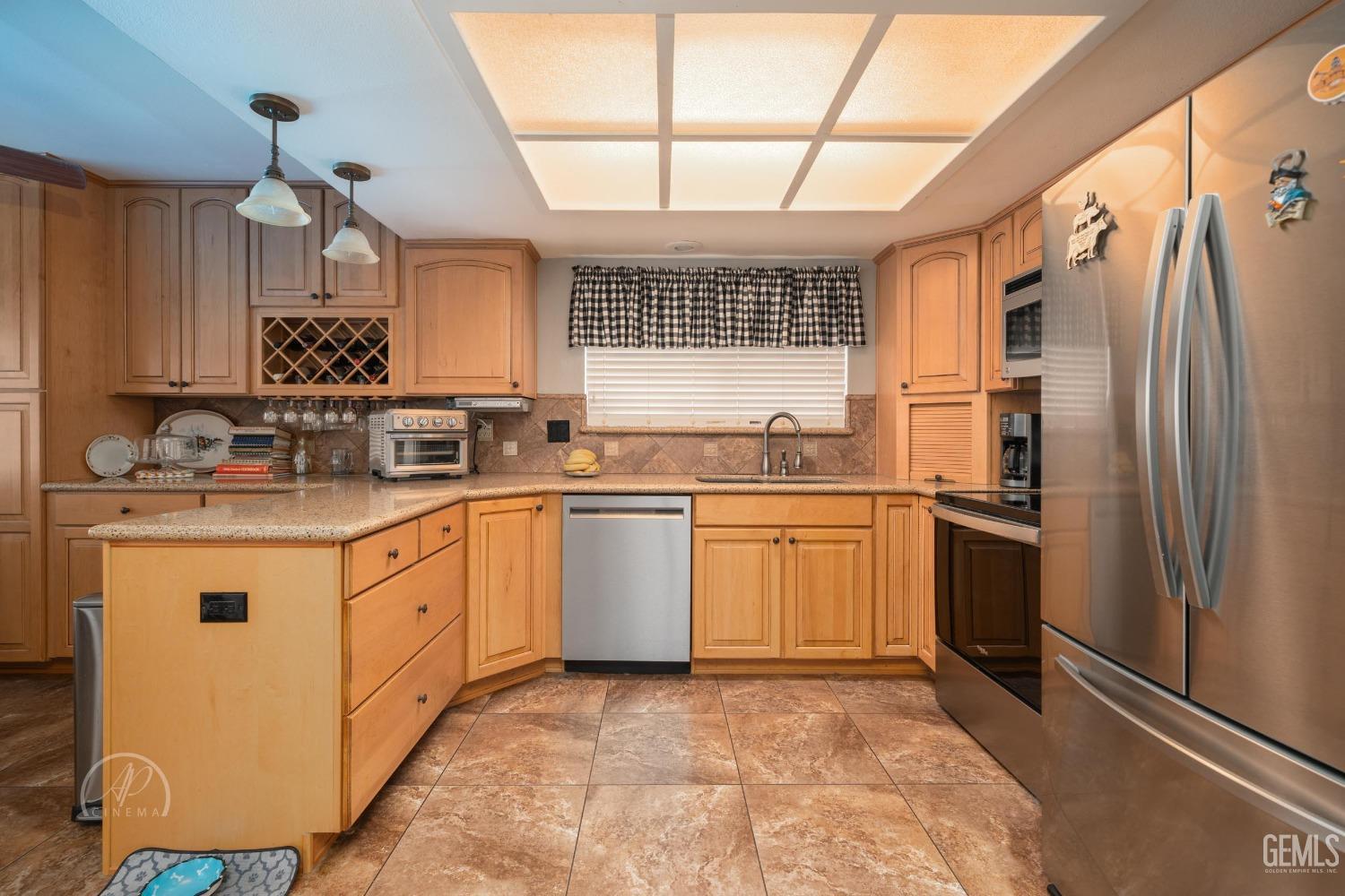 Undisclosed Address Taft, CA 93268 - Photo 9 of 32 a kitchen with granite countertop a refrigerator sink and cabinets