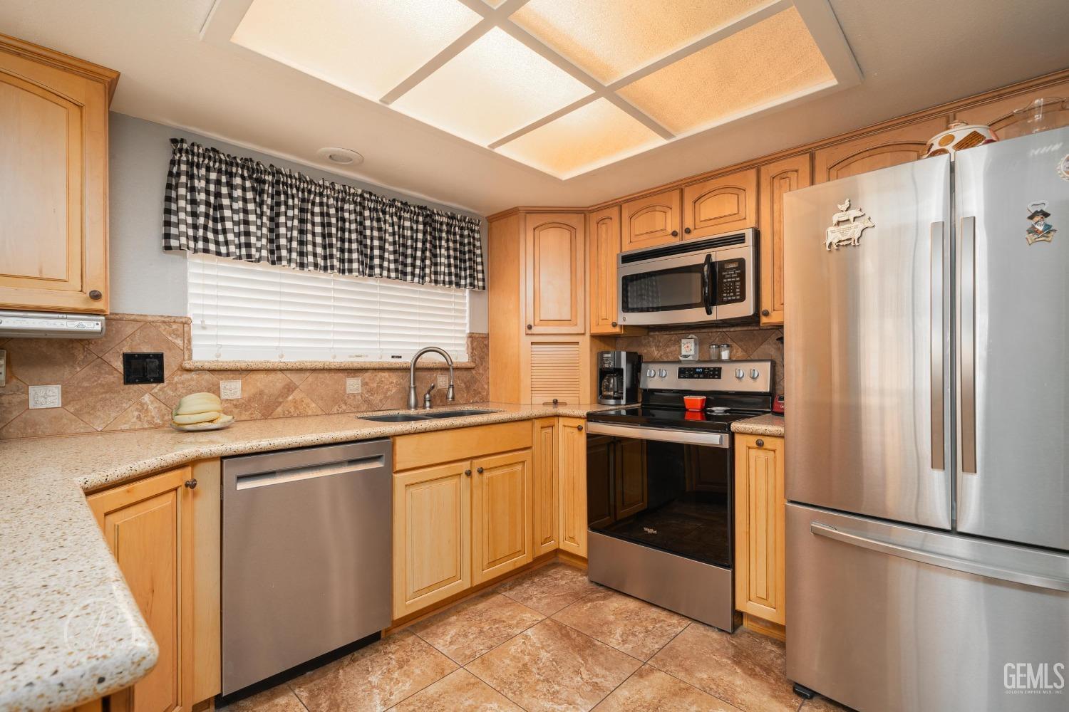 Undisclosed Address Taft, CA 93268 - Photo 10 of 32 a kitchen with stainless steel appliances granite countertop a refrigerator and a sink