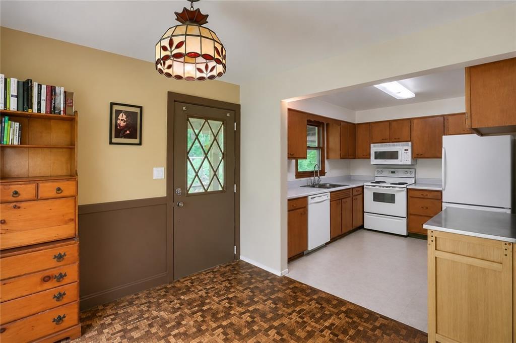 149 Seneca School Road Harmony, PA 16037 - Photo 21 of 50 Open to the kitchen. Hardwood floors under the lamintate. Door leads to the large covered patio with views of nothing but nature.