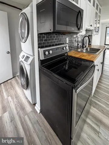 a kitchen with granite countertop a sink and a stove top oven