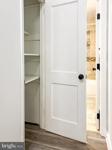 a view of a room with wooden floor