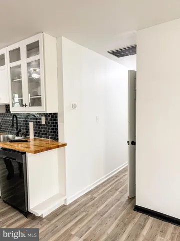 a view of a room with wooden floor