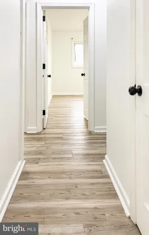 a view of a room with wooden floor and fan