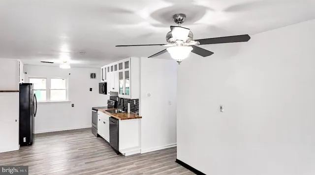 a kitchen with stainless steel appliances a refrigerator and a chandelier