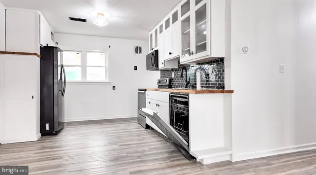 a kitchen with stainless steel appliances granite countertop a stove and a refrigerator