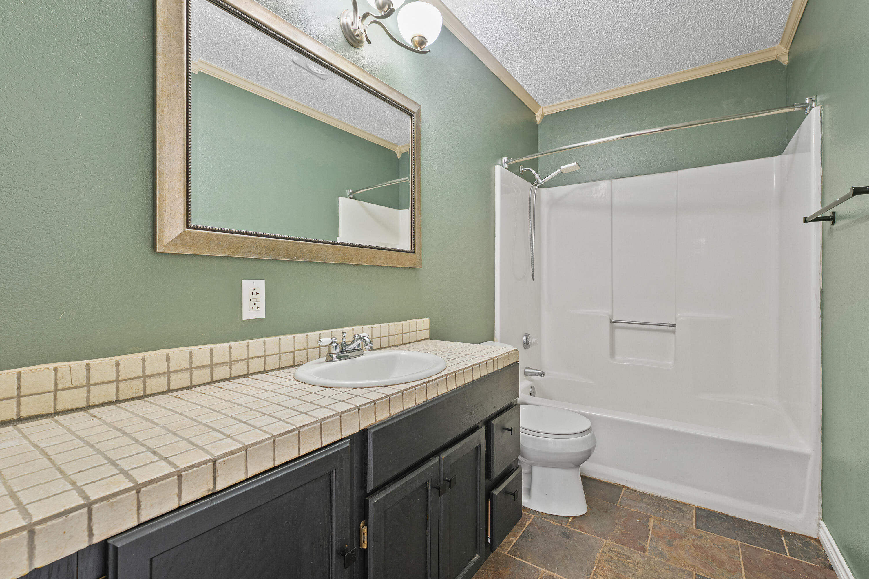 5705 Itasca Street Lubbock, TX 79416 - Photo 6 of 10 a bathroom with a sink a toilet and shower