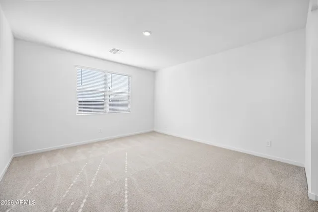 a view of an empty room and closet area