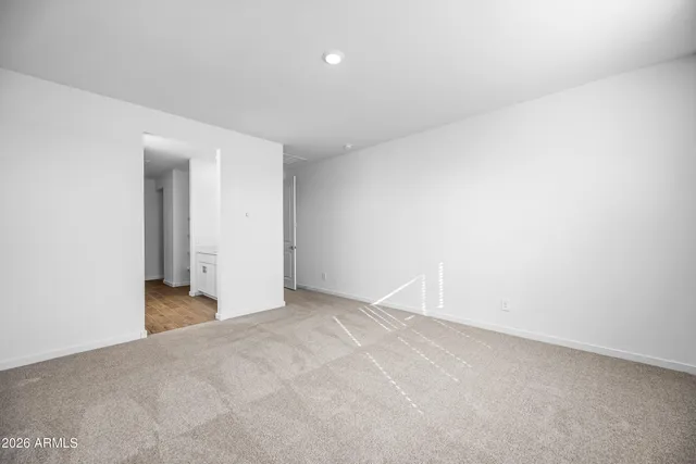 a spacious bathroom with a tub sink and mirror