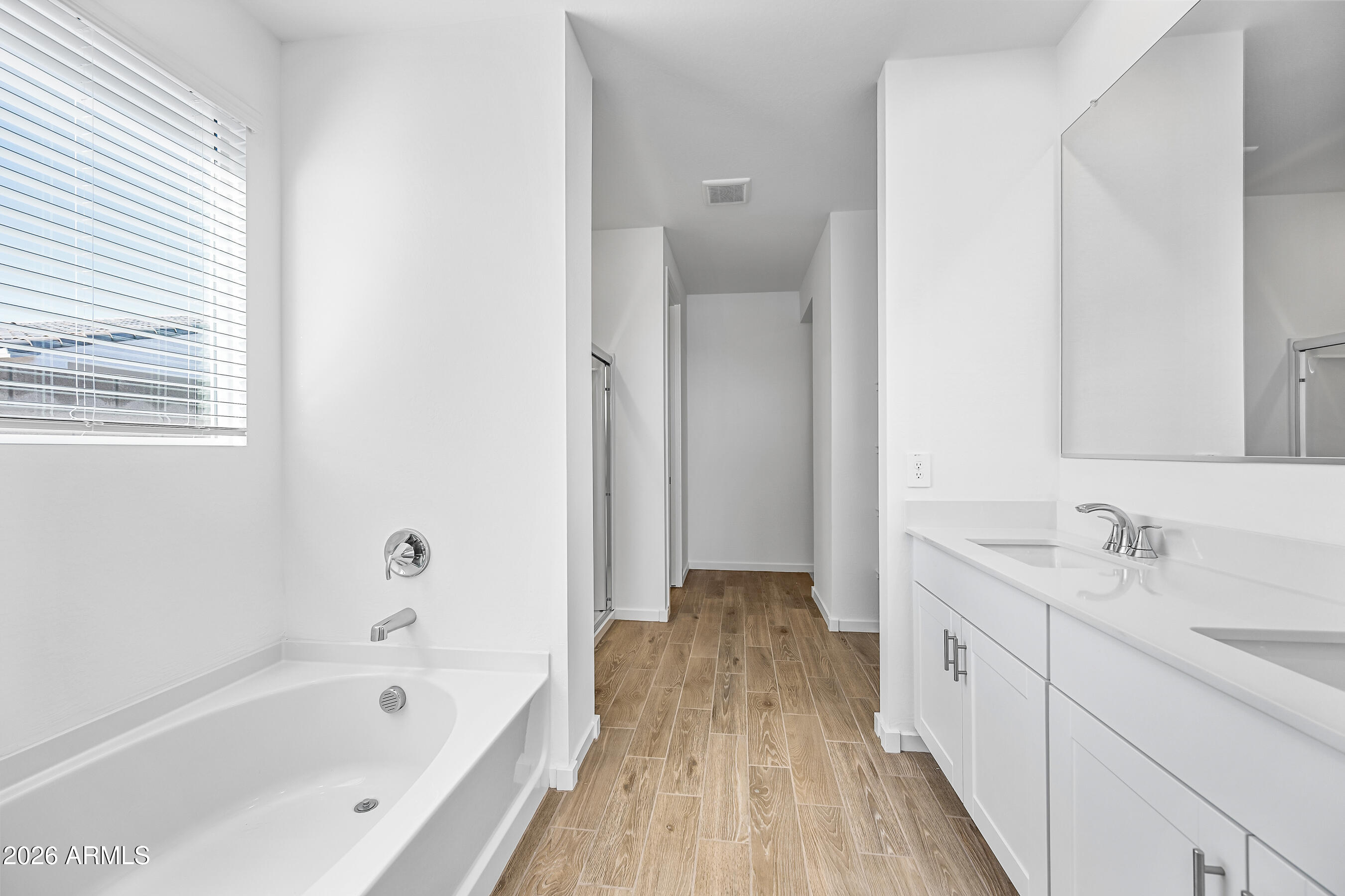 2563 Grenache Road San Tan Valley, AZ 85143 - Photo 14 of 25 a spacious bathroom with a tub sink and mirror