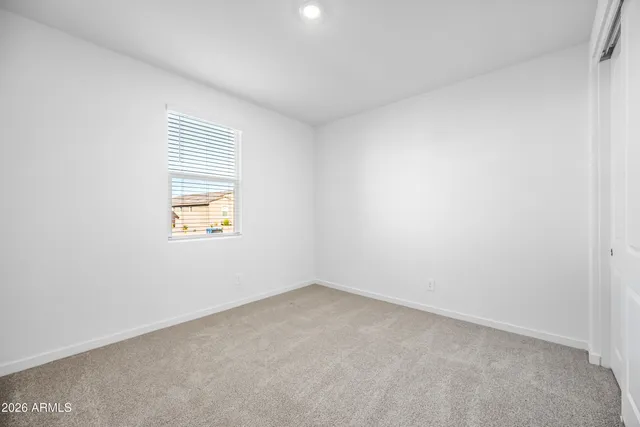 a bathroom with a granite countertop sink toilet and a mirror