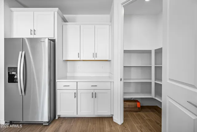 a kitchen that has a sink a stove and a wooden floor