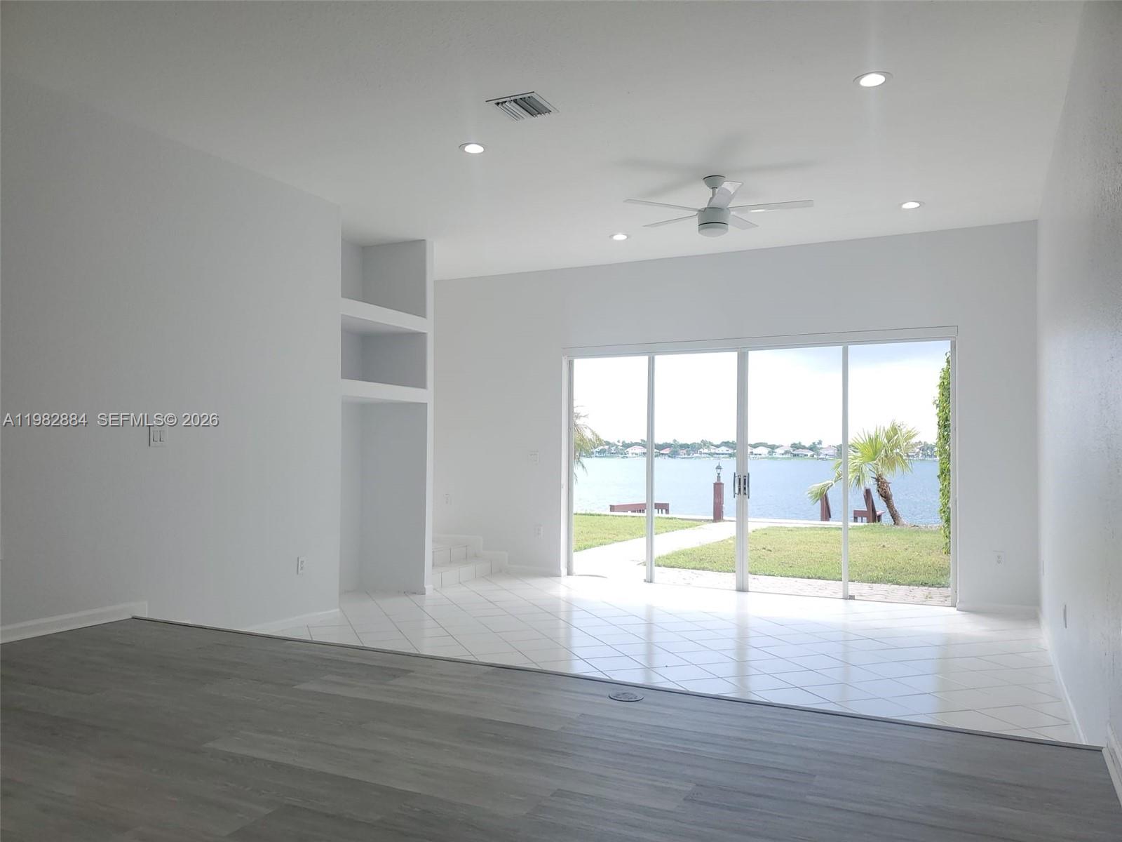 14765 Southwest 132nd Place Miami, FL 33186 - Photo 15 of 52 a view of an empty room with wooden floor and a window