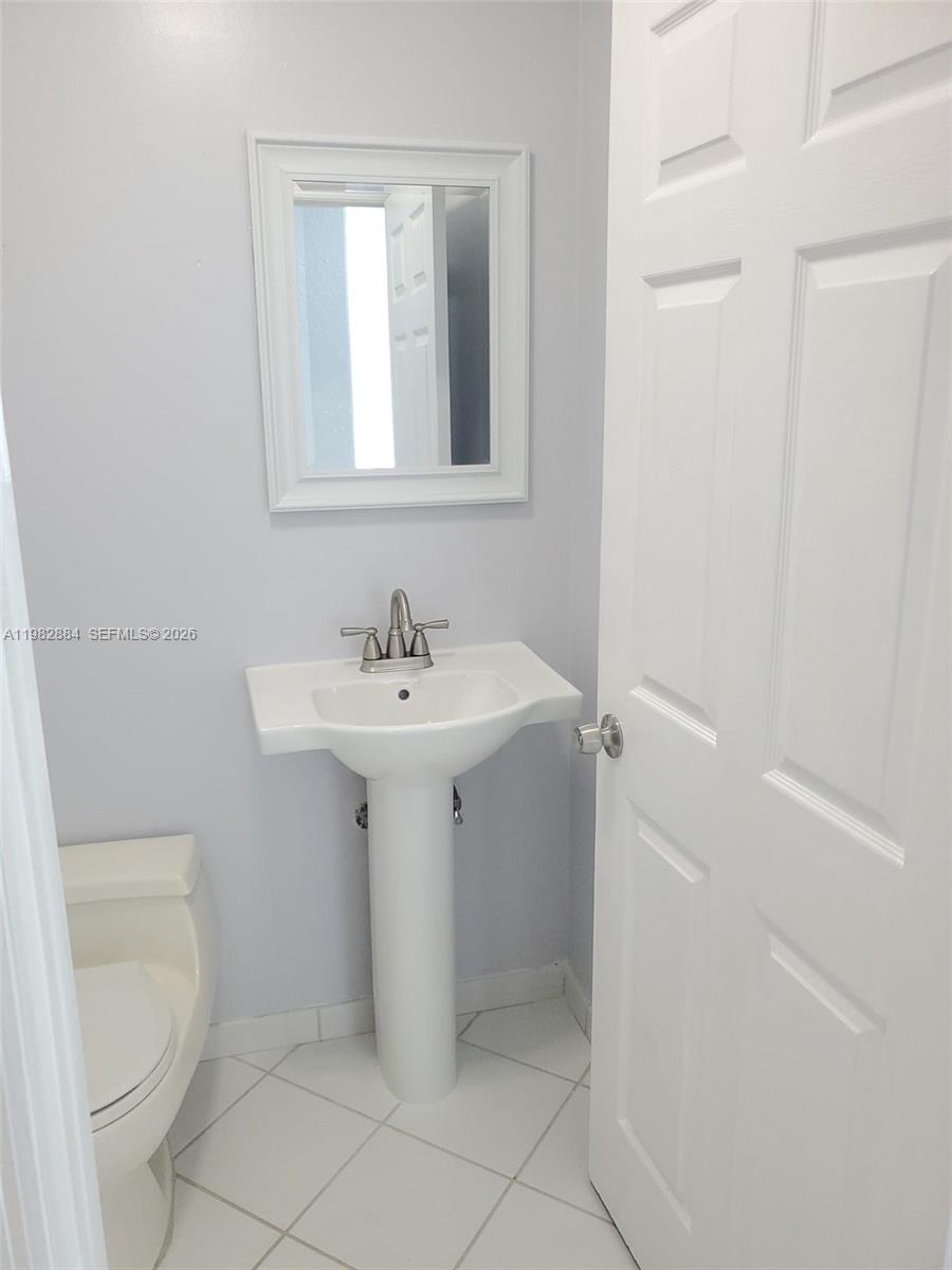 14765 Southwest 132nd Place Miami, FL 33186 - Photo 16 of 52 a bathroom with a sink toilet and a mirror