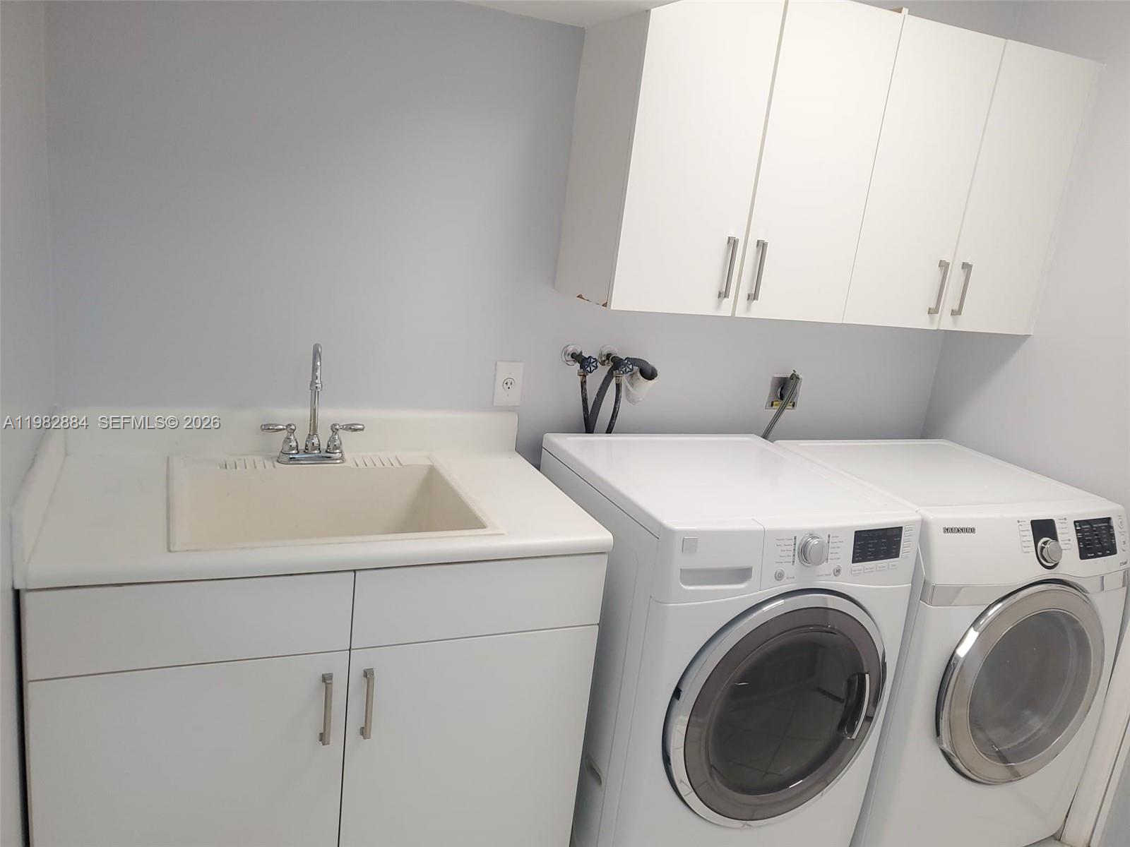 14765 Southwest 132nd Place Miami, FL 33186 - Photo 17 of 52 a utility room with dryer and washer