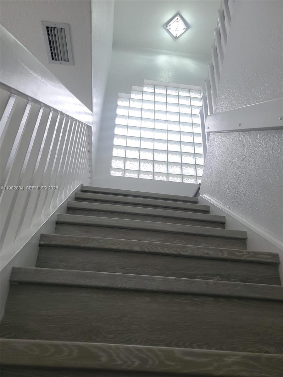 14765 Southwest 132nd Place Miami, FL 33186 - Photo 18 of 52 a view of entryway and hall with wooden floor