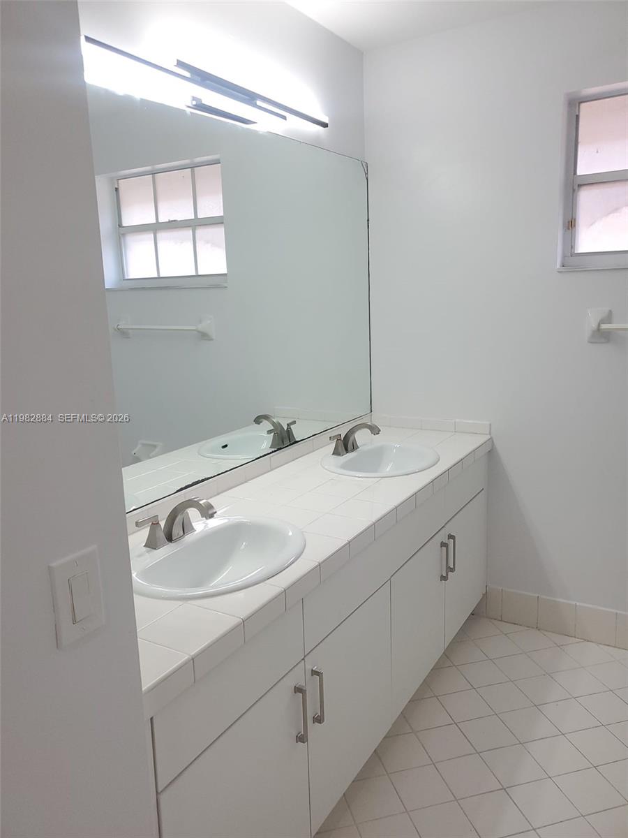 14765 Southwest 132nd Place Miami, FL 33186 - Photo 22 of 52 a bathroom with a sink and a mirror