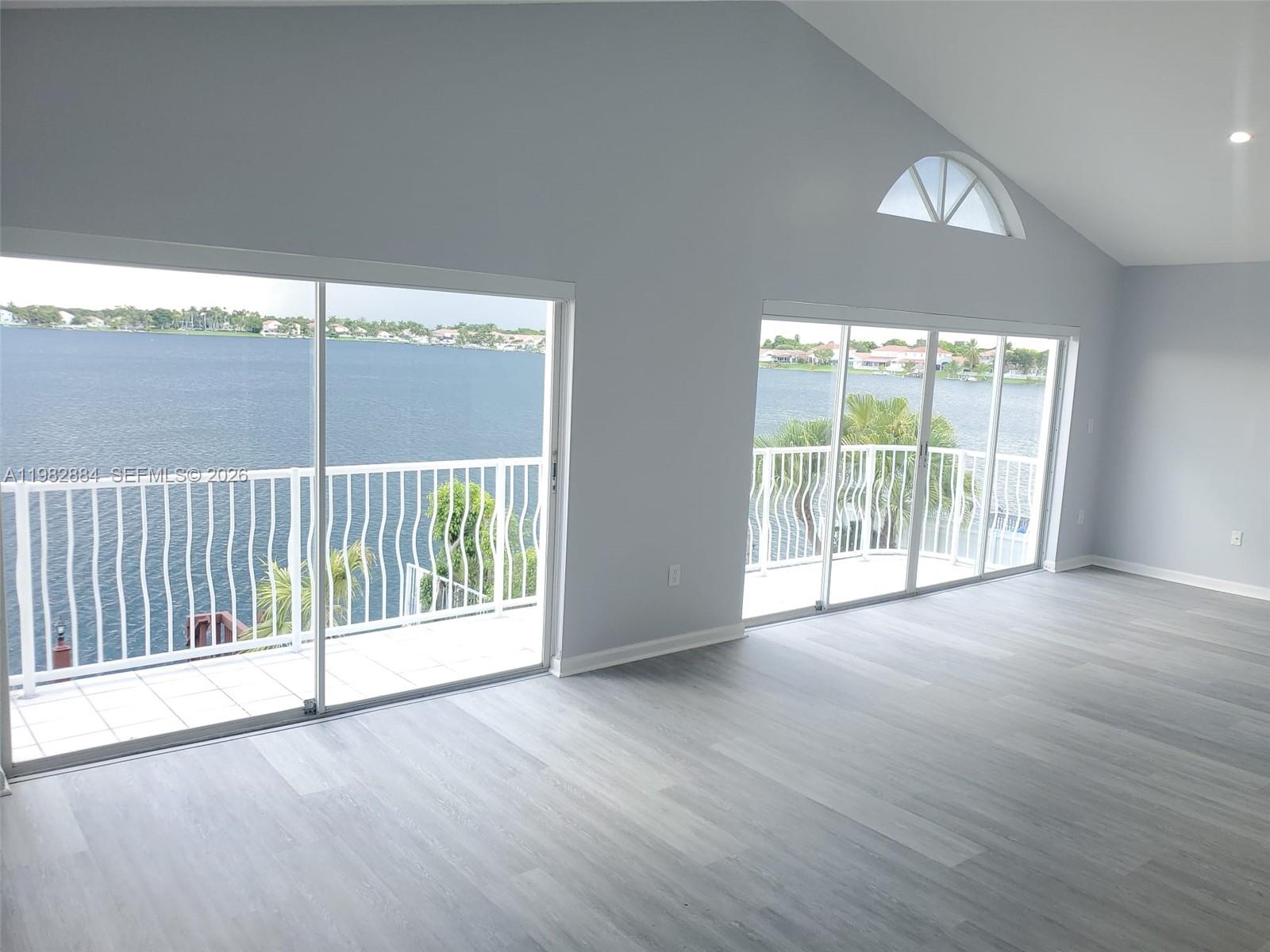 14765 Southwest 132nd Place Miami, FL 33186 - Photo 23 of 52 an empty room with wooden floor and windows