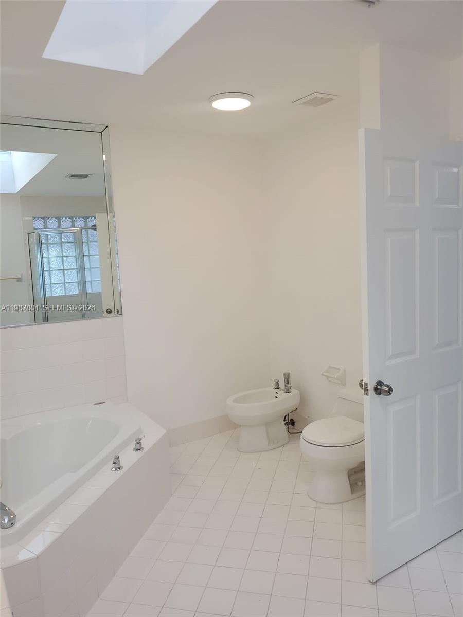 14765 Southwest 132nd Place Miami, FL 33186 - Photo 28 of 52 a bathroom with a toilet and a bathtub