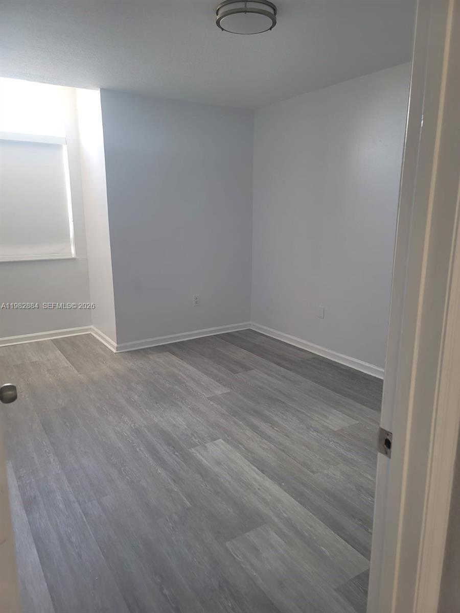 14765 Southwest 132nd Place Miami, FL 33186 - Photo 38 of 52 wooden floor in an empty room