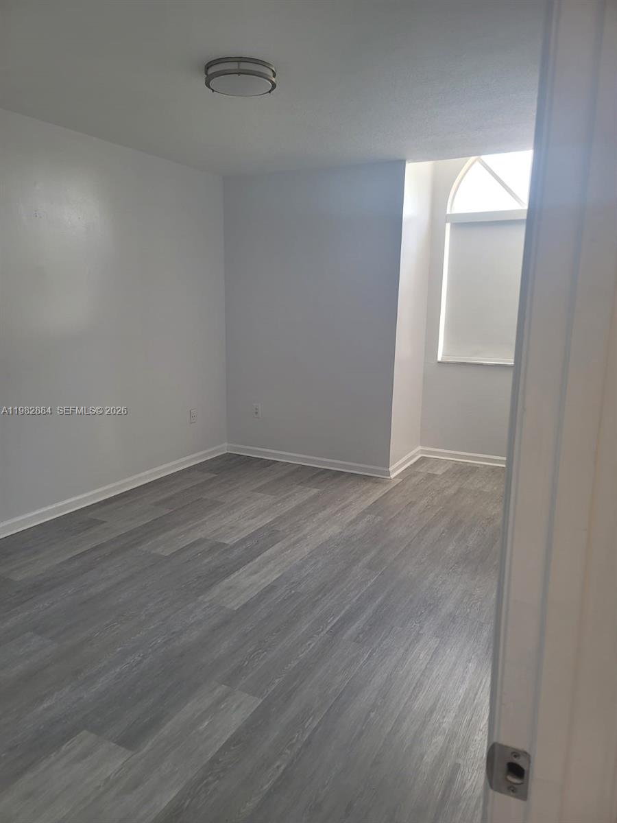 14765 Southwest 132nd Place Miami, FL 33186 - Photo 39 of 52 wooden floor in an empty room