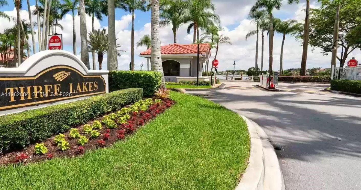14765 Southwest 132nd Place Miami, FL 33186 - Photo 52 of 52 a front view of multi story residential apartment building with yard and sign board