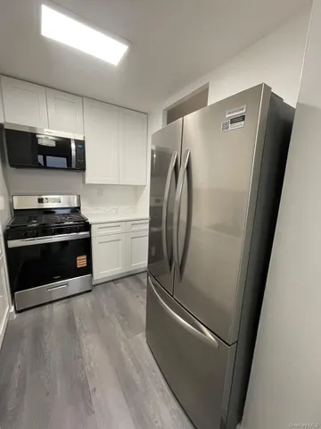 a metallic refrigerator freezer sitting in a kitchen