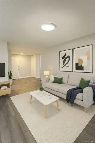 a living room with furniture and a potted plant