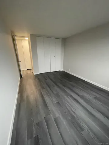 a view of a room with wooden floor and white walls