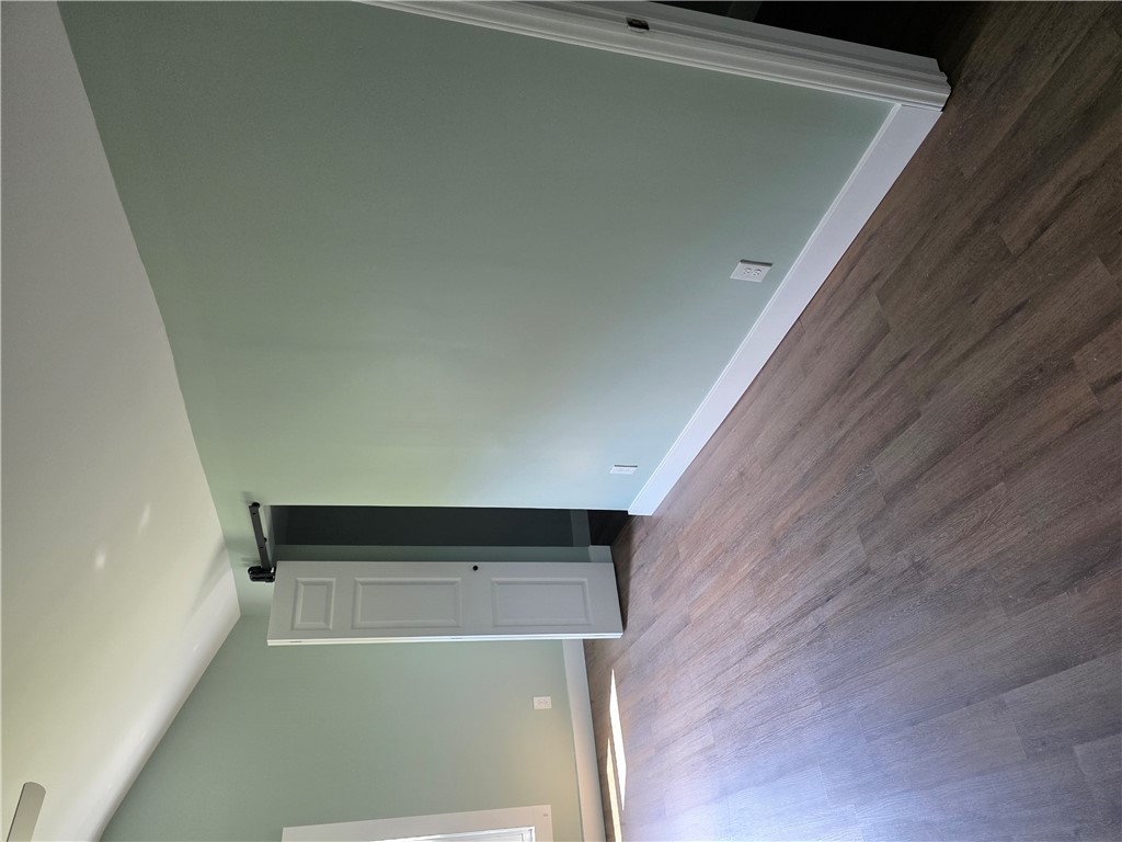 112 Simmons Street Anderson, SC 29625 - Photo 12 of 26 Clean hardwood-style flooring extends across this freshly painted room.